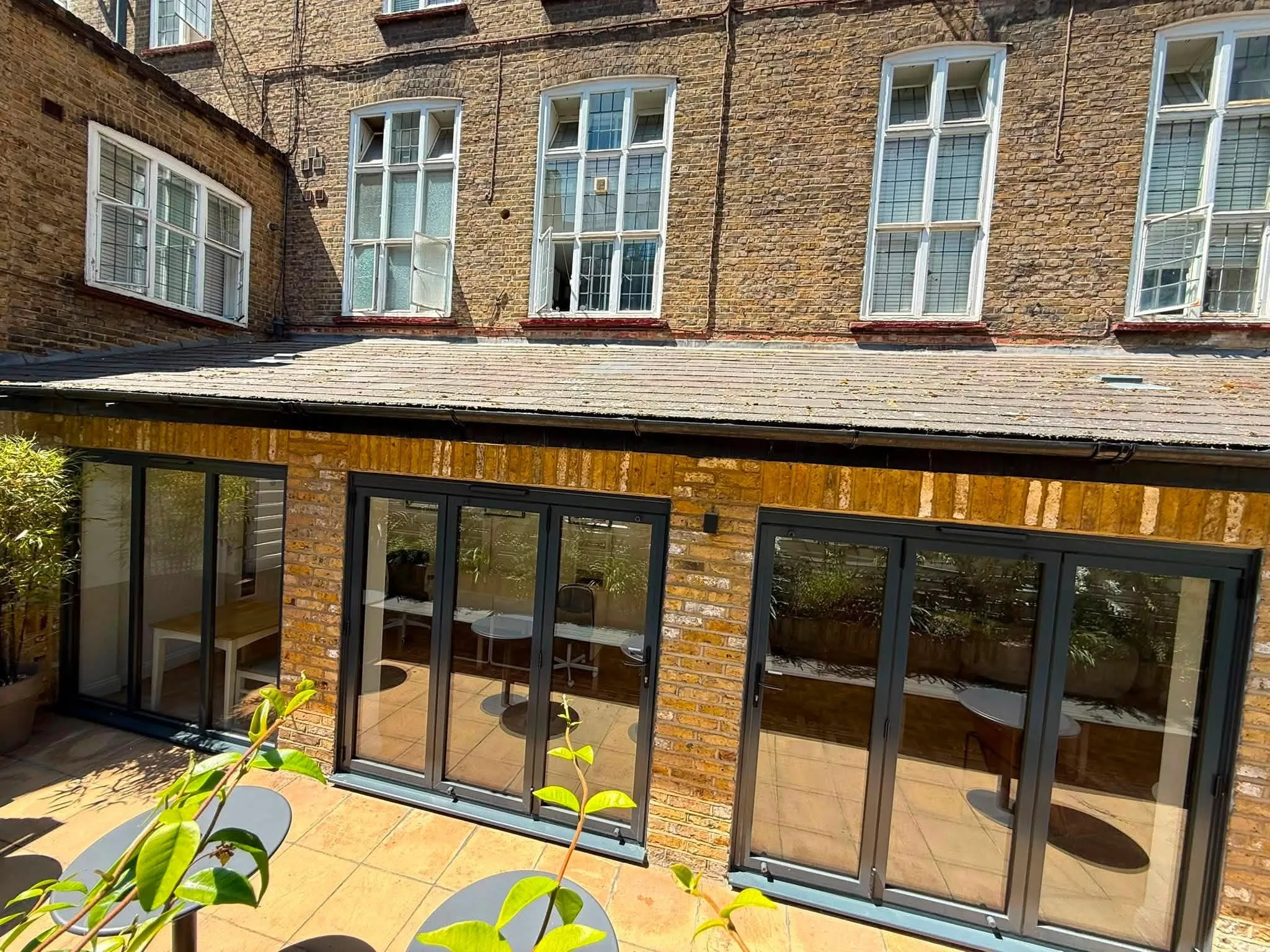 Brick orangery extension with anthracite aluminium bifold doors built by Holtye Windows