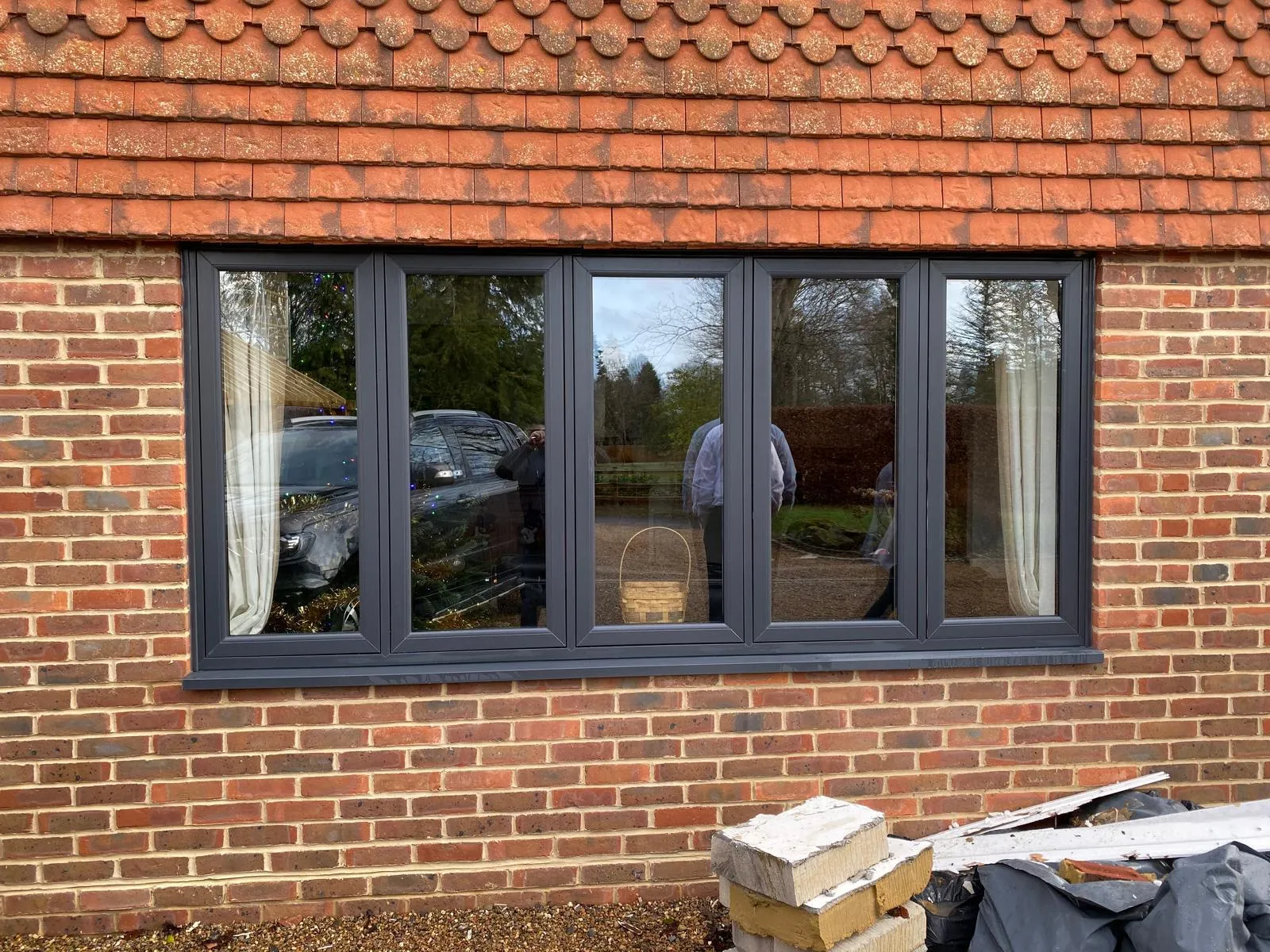 Run of anthracite grey aluminium windows in a brick barn conversion