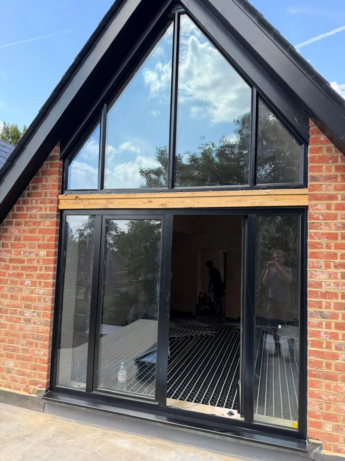 Black aluminium apex glazing above sliding doors