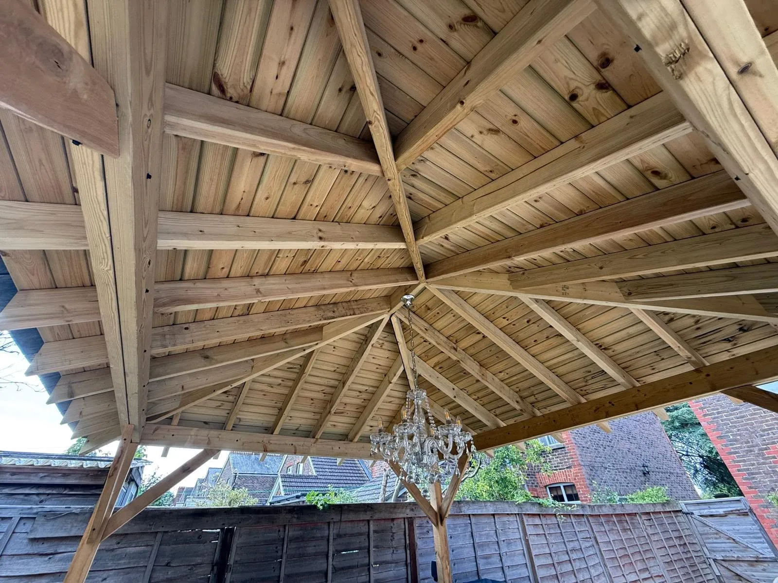Underside of the pergola roof, showing the timber frame and boarded ceiling