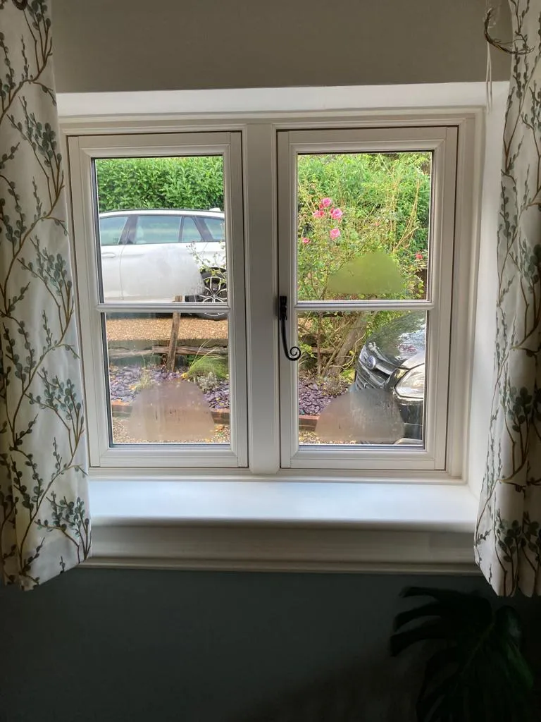 White French doors viewed from inside, looking out onto a garden