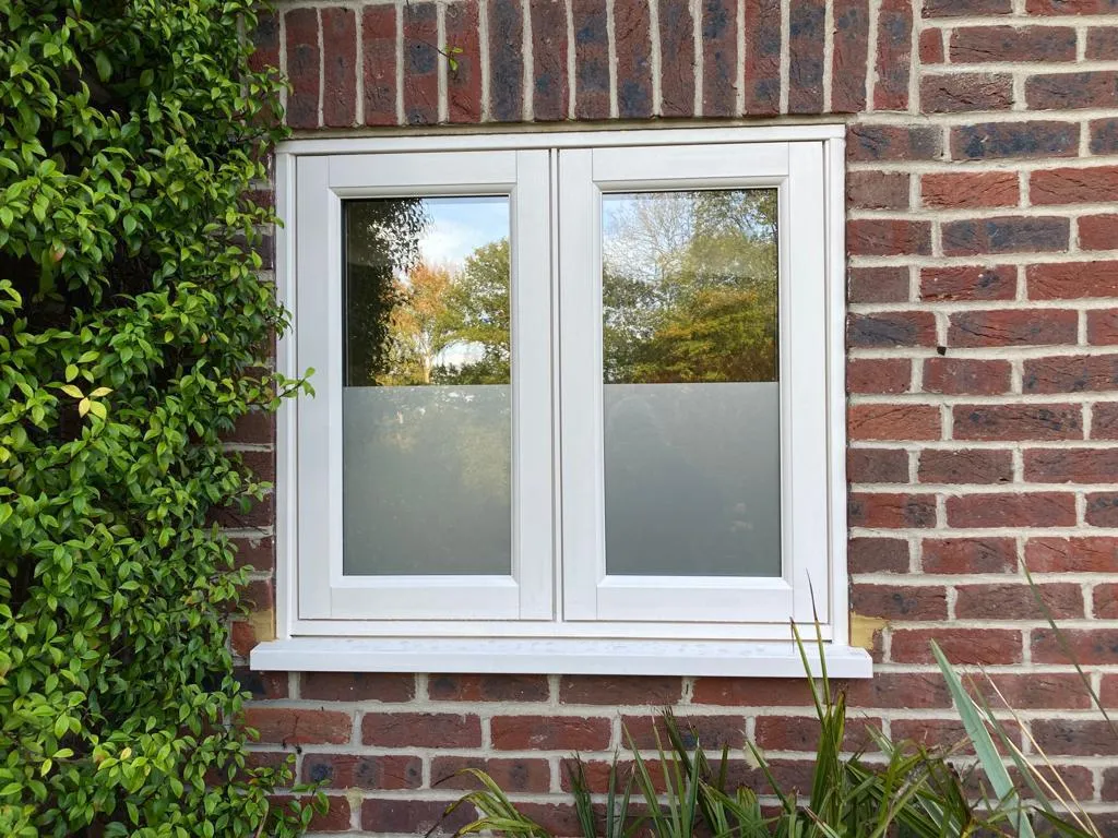 Replacement double glazed window with obscure glazing in a brick wall